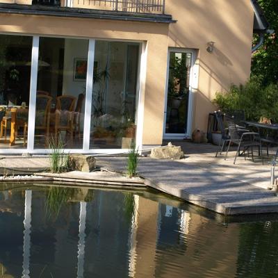 Naturpool mit glasklarem Wasser direkt am Haus, Terrasse aus Robinie